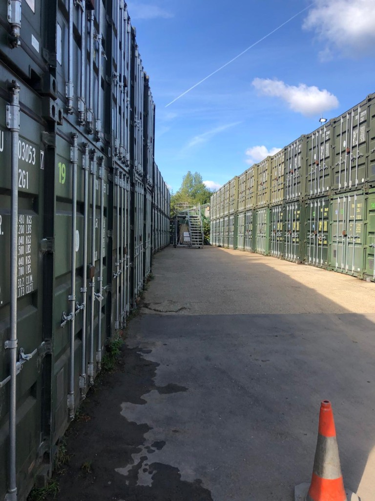 Stacked containers either side of an aisle on the Elstree Storage yard